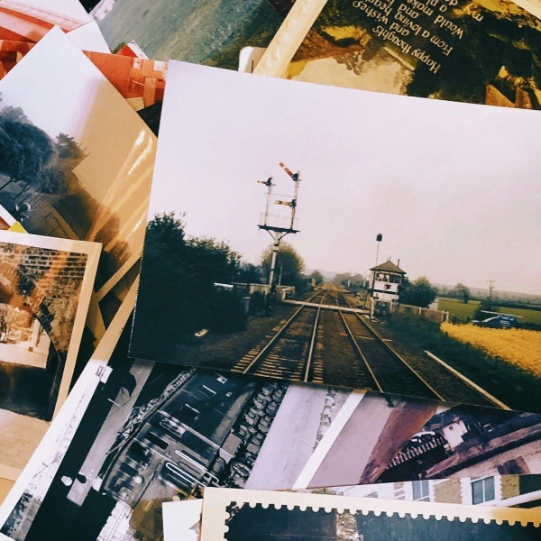 Scattered photographs on a desk representing memory and the past