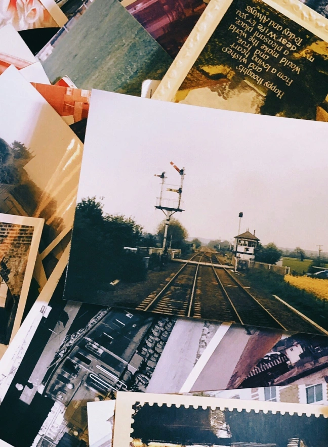 Scattered photographs on a desk representing memory and the past